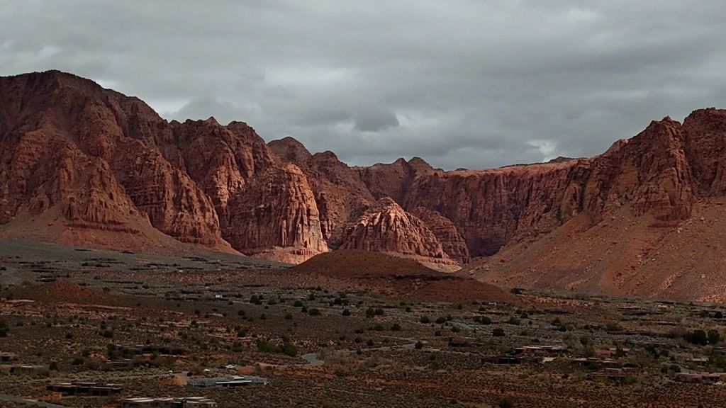 Red rock cliffs under gray storm clouds near Ivins, Utah