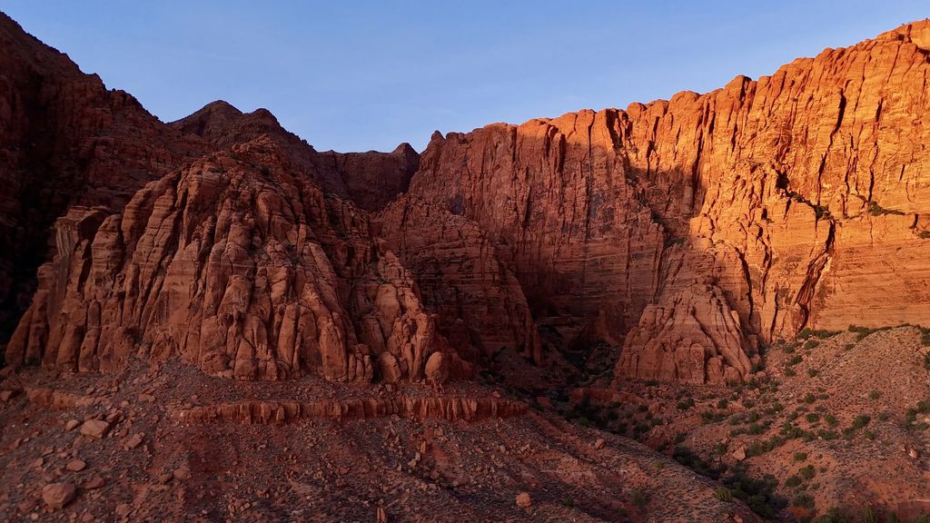 Sunlit red sandstone cliffs near Ivins, Utah, photographed by Robert Bolar